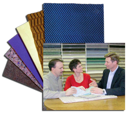 Salesman with Couple looking over samples of Carpet and Cushions